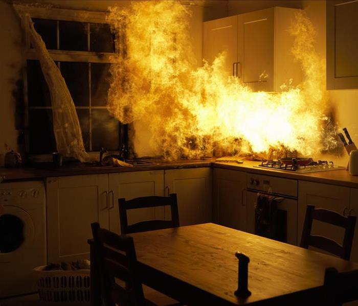 Active blazing fire on a kitchen stove. 
